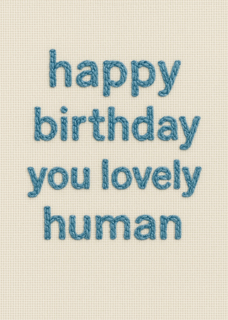 Blue embroidered happy birthday you lovely human message on cream fabric