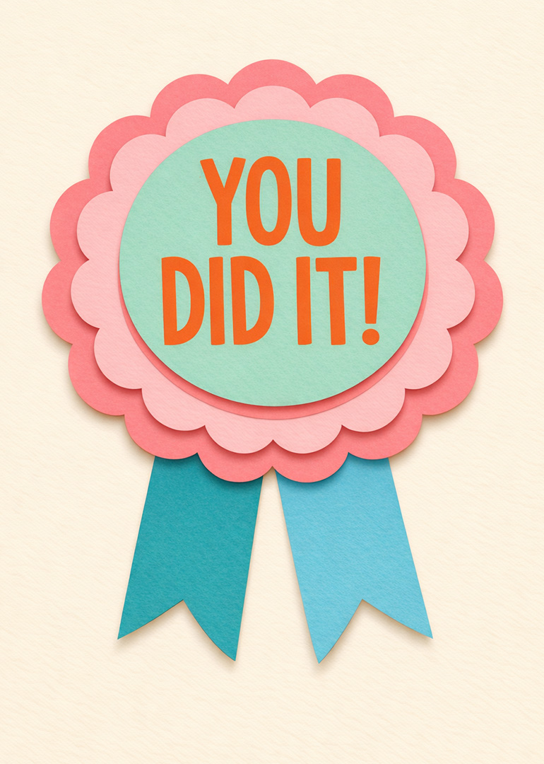 Paper rosette badge with ribbons saying You Did It in bold letters