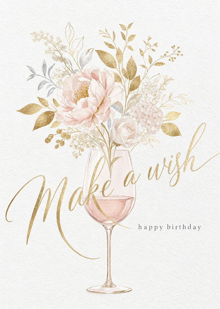 Pink flowers rise from a wine glass beside gold script reading Make a wish today.