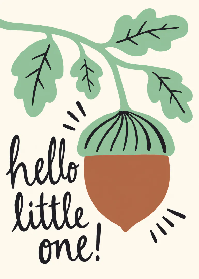 Cream card with a large brown acorn, green oak leaves and the words “hello little one!” in black script.