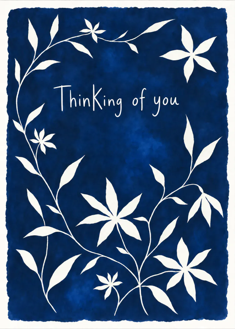 Deep blue card with a white floral vine border and the words “Thinking of you”.