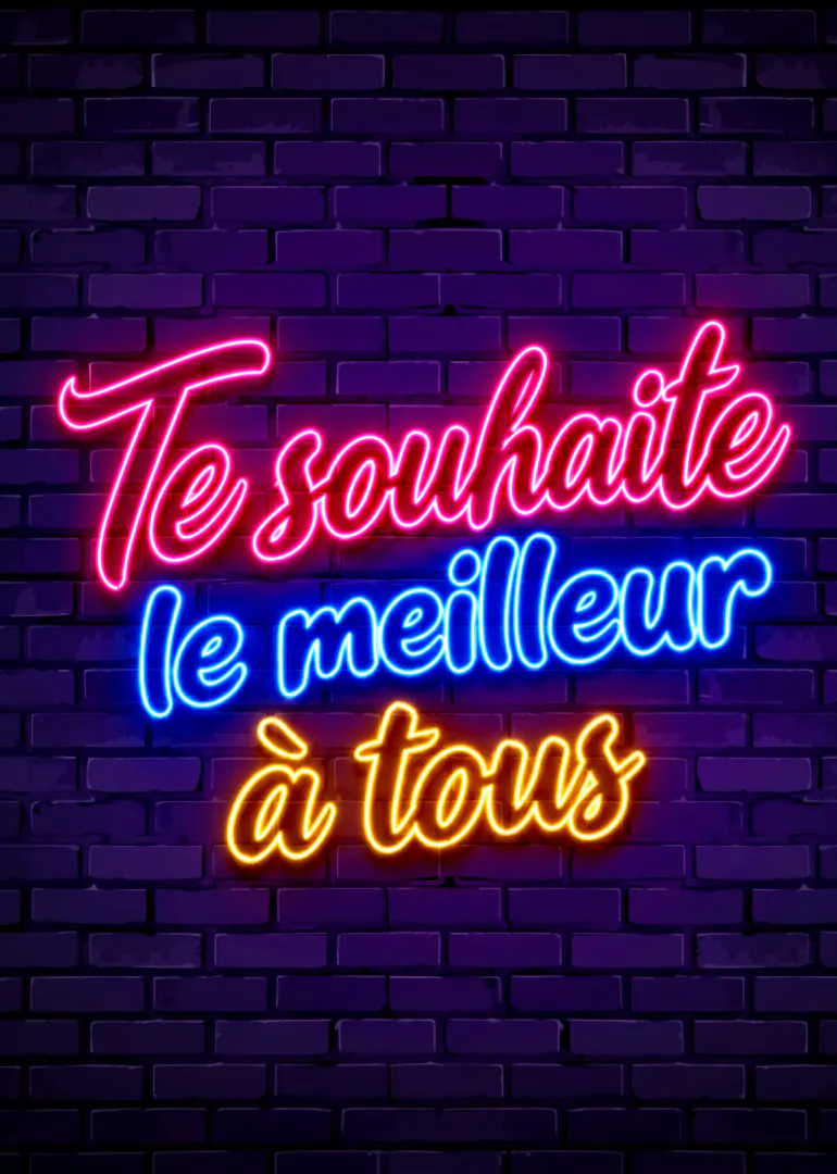 Lettrage néon rose, bleu et jaune sur un mur de briques violet foncé : « Te souhaite le meilleur à tous ».