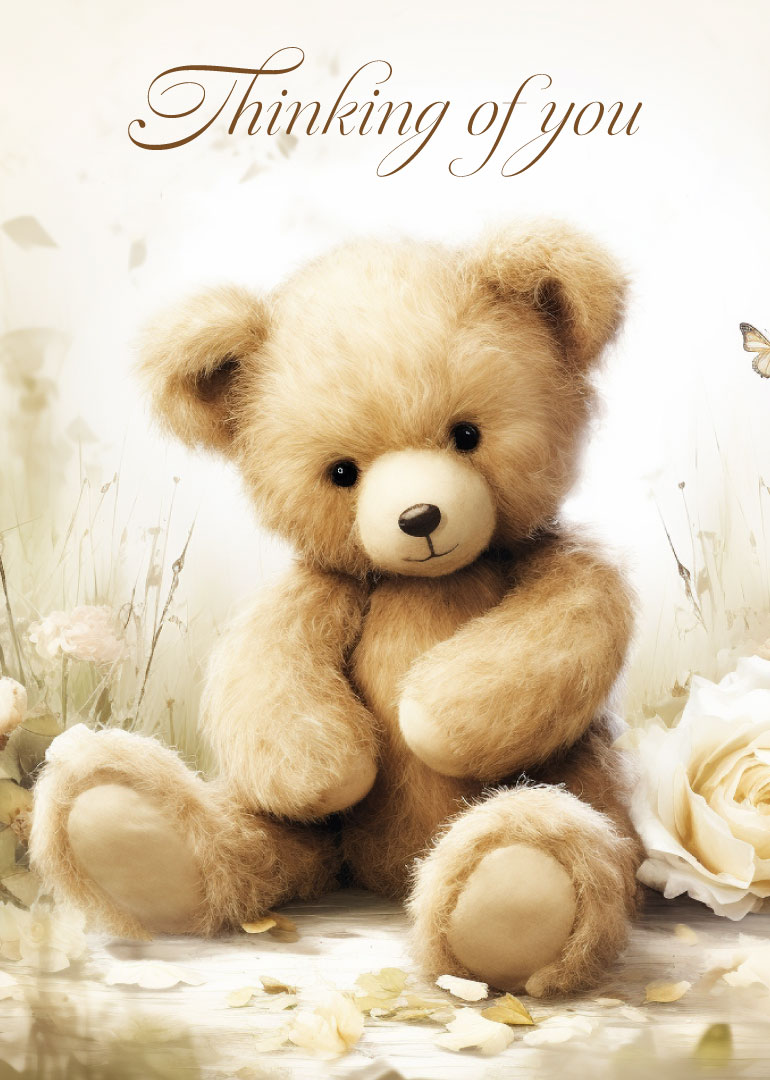 Soft teddy bear sitting among flowers with thinking of you text