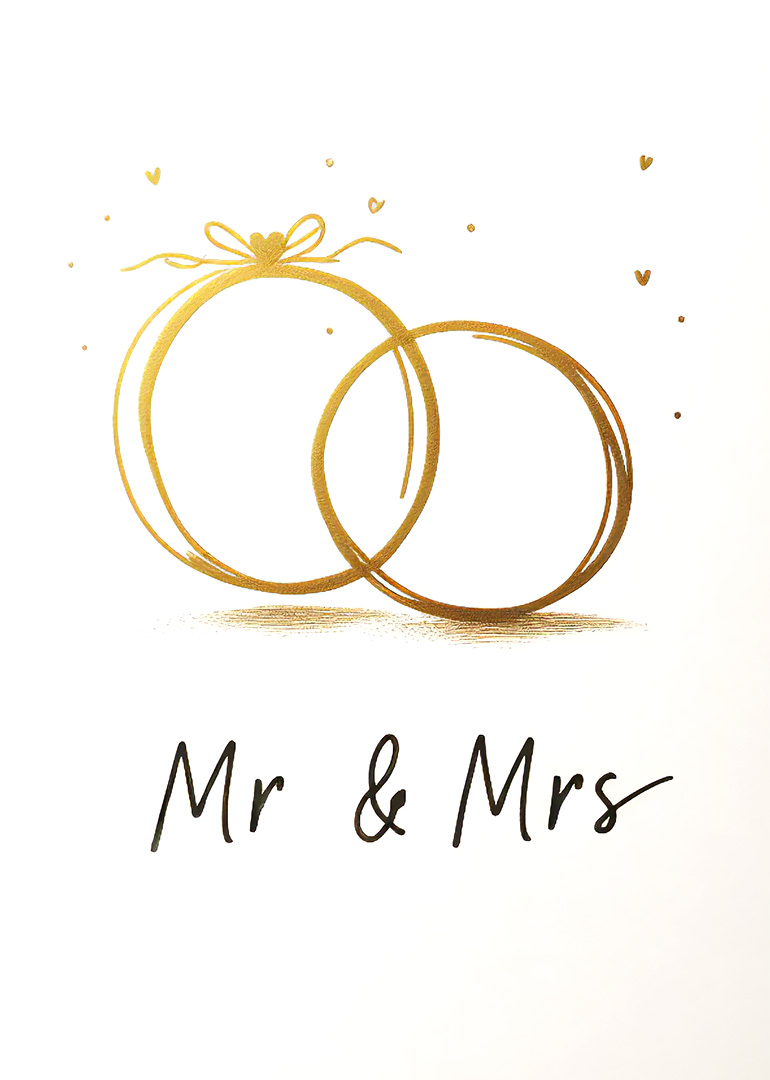 Gold wedding rings with Mr and Mrs text on white background
