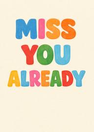Colorful block letters spelling miss you already on cream