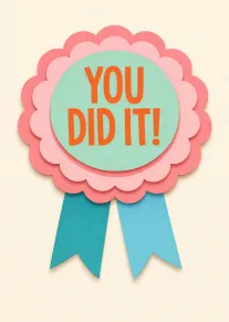Pastel paper rosette card with You Did It text in orange and blue ribbons below.