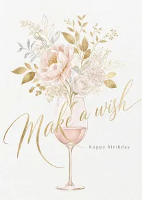 Pink flowers rise from a wine glass beside gold script reading Make a wish today.