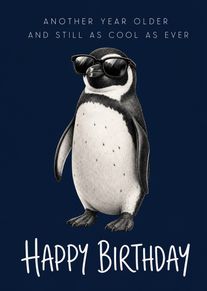 A penguin in sunglasses with happy birthday text on a dark blue background looking cool.