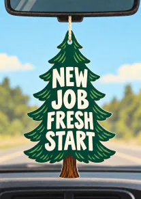 Illustrated green pine tree car air freshener reading “NEW JOB FRESH START” against a sunny road background.