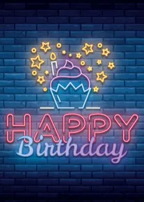 Neon cupcake and stars glow above the words Happy Birthday on a blue brick wall.