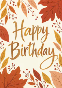 Happy Birthday card with golden handwritten lettering surrounded by autumn leaves and red berries.