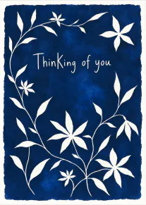 Deep blue card with a white floral vine border and the words “Thinking of you”.