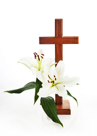 Wooden cross with white lilies symbolizing sympathy and remembrance