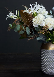 Elegant white floral bouquet in textured silver vase