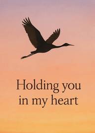 Silhouette of flying bird with heartfelt message at sunset