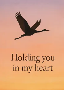 Silhouette of a flying bird against a sunset sky with Holding you in my heart.