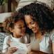 A mom and daughter smiling while reading a funny Mother's Day card