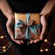 Photograph of a person holding a beautifully wrapped dinner party gift