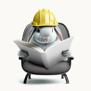 Bunny Wearing a Hard Helmet Reading on a Chair