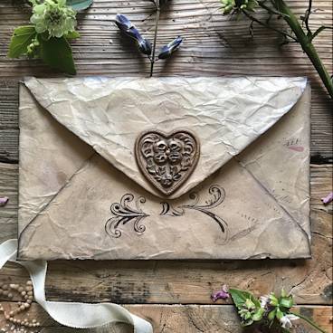 Antique-style love letter with heart seal and flowers -