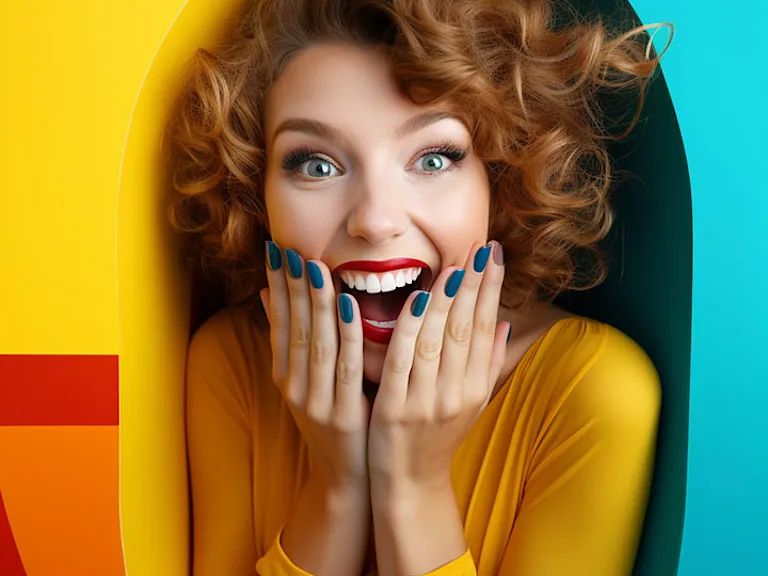 Woman laughing against colourful background