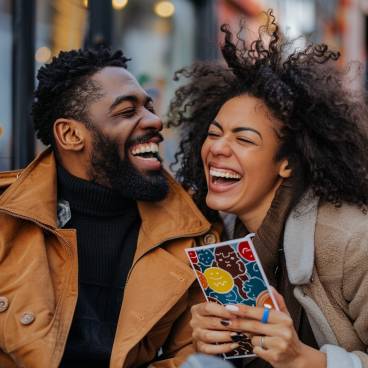 Couple laughing together with a funny greeting card 