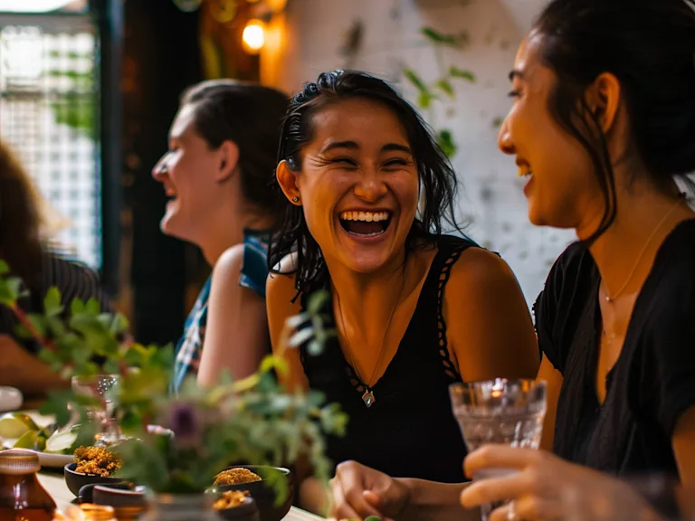 A team laughing together at a casual meal