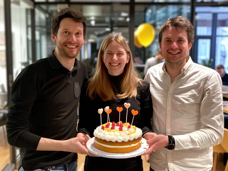 Colleagues celebrating a work anniversary with a cake